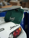 Raskol JR. Nefti Yeşil Sweatshirt hanging on a car with a SUPRA Turbo logo, showcasing denim details.